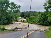 Floodwaters pour over Route 21 in the Steuben County community of Hedgesville. (Annette Helen)