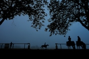 In this June 7, 2024, file photo, outriders watch horses work out ahead of the 156th running of the Belmont Stakes horse race at Saratoga Race Course in Saratoga Springs, N.Y. (AP Photo/Julia Nikhinson)