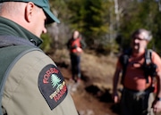 Forest ranger talks to hikers on the summit of Mt. Van Hoevenberg, where last week a hiker was ticketed for harassing three other hikers.