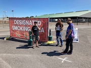 A group of smokers using the the designated smoking area outside Gate 10 at the 2023 New York State Fair. (Don Cazentre)