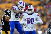 Buffalo Bills defensive end Greg Rousseau (50) celebrates a sack with AJ Epenesa (57) during the first half of an NFL exhibition football game against the Pittsburgh Steelers, Saturday, Aug. 17, 2024, in Pittsburgh. (AP Photo/Matt Freed)