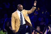 Dwight Freeney, a member of the Pro Football Hall of Fame Class of 2024, celebrates after receiving his gold jacket during the gold jacket dinner Aug. 2 in Canton, Ohio. (AP Photo/Gene J. Puskar)