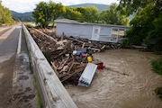 A mobile home swept from its foundation is seen lodged about 1,000 feet away from the property where it stood near a bridge on the Canisteo River, Friday, Aug. 9, 2024, in Canisteo, N.Y., after remnants of Tropical Storm Debby swept through the area. (AP Photo/Craig Ruttle)