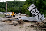 Debris from a building is seen along Route 36 in Canisteo, N.Y., Friday, Aug. 9, 2024, after remnants of Tropical Storm Debby swept through the area. (AP Photo/Craig Ruttle)