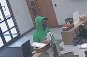 A man wearing a green hooded sweatshirt, sunglasses and a mask robbed the CFCU Federal Credit Union in North Syracuse on Monday, Aug. 12, 2024.