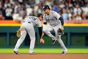 New York Yankees second baseman Gleyber Torres (25) and right fielder Juan Soto celebrate the team's win over the Detroit Tigers in a baseball game, Friday, Aug. 16, 2024, in Detroit. (AP Photo/Carlos Osorio)