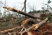 Joshua Jewell works to clear downed trees from around a storm damaged home Friday, Jan. 13, 2023, in Jackson, Ga. Powerful storms spawned tornadoes across Georgia Thursday night. (AP Photo/John Bazemore)