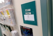 FILE - This July 12, 2012 file photo, show an exam room at Nuestra Clinica Del Valle, in San Juan, Texas. Some employers are considering adding a surcharge to cover the health care expenses of their workers' spouses. Others, like package deliverer United Parcel Service Inc., are excluding spouses from coverage if they are able to get insurance through another employer. (AP Photo/Eric Gay, File)