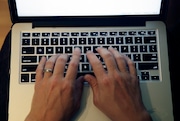 This Monday, June 19, 2017, photo shows fingers on laptop keyboard in North Andover, Mass. (AP Photo/Elise Amendola)