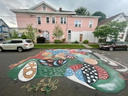 Daniela Nikolavsky installed this mural on North McBride Street on Syracuse's Northside. The mural was designed by refugee women in a local art therapy group. (Katrina Tulloch)