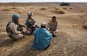 In this Friday, Dec. 11, 2009, file photo, United States Marine Sgt. Isaac Tate, left, and Cpl. Aleksander Aleksandrov, center, interview a local Afghan man with the help of a translator from the 2nd MEB, 4th Light Armored Reconnaissance Battalion on a patrol in the volatile Helmand province of southern Afghanistan. When the U.S. pulled out of Afghanistan three years ago, hundreds of former translators and others who helped the war effort were evacuated -- but many more were left behind. (Kevin Frayer | AP)